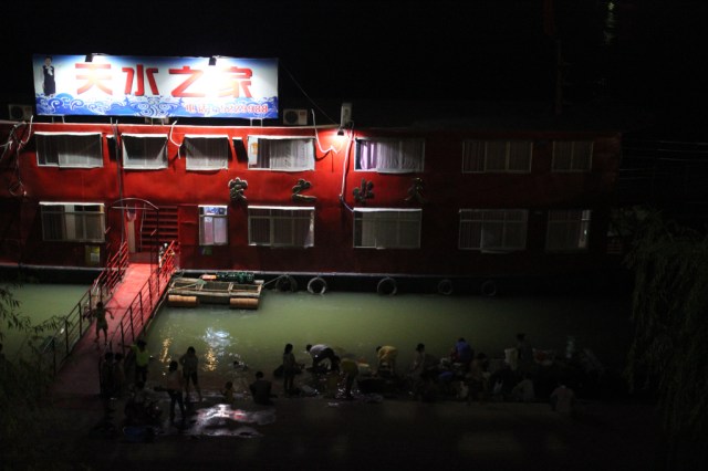 Danjiangkou locals outside a restaurant along the river. Quartz / Lily Kuo.