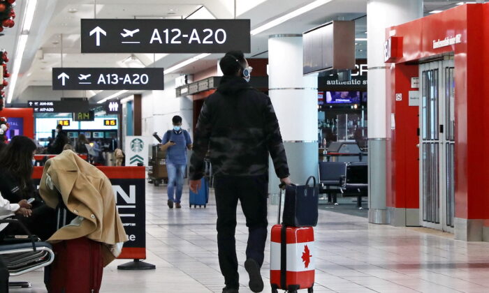 FILE PHOTO: United States-bound passengers walk in Toronto Pearson Airport